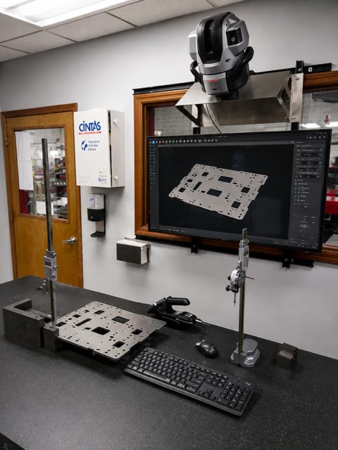 Keyence XM-5000 handheld probe coordinate measuring machine inspecting a large sheet metal panel at MJM Manufacturing